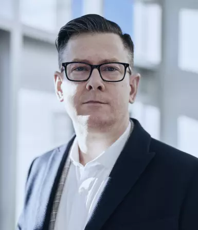 a man wearing glasses and a suit